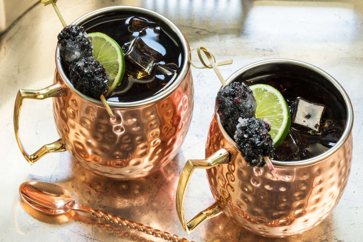 cups of Sweet Tea Mule cocktail with sugared blackberries