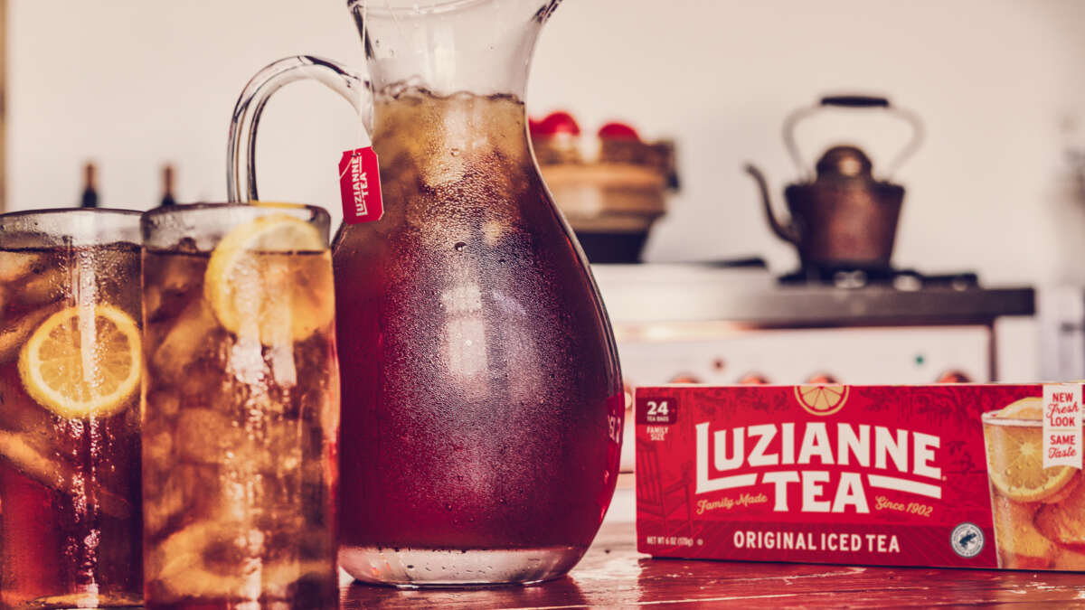 Pitcher if Luzianne iced tea on a table with 2 glasses