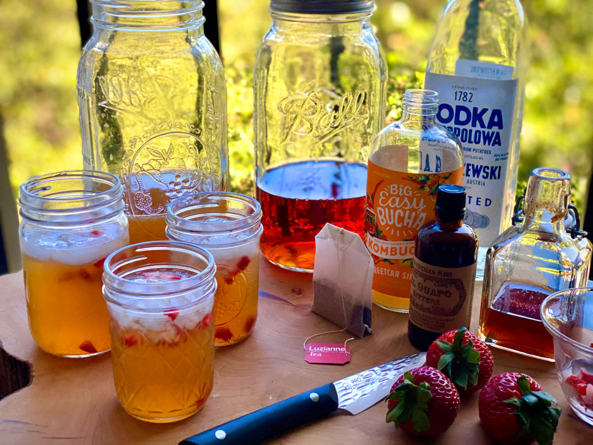 Three Jars Of Swamp Water Tea Cocktail On Table