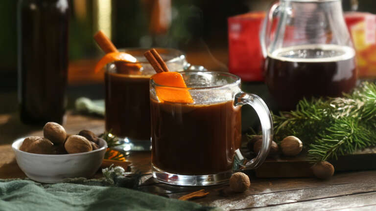 Hot Buttered Rum and Tea Toddy in clear mugs