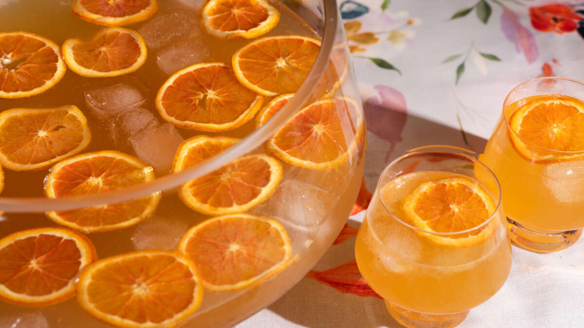 imperial honeyed peach punch in punch bowl with glasses