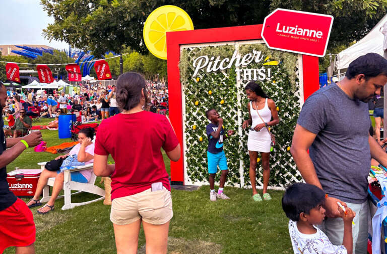 Luzianne Fans line up to take a photo at the "pitcher this" festival photo wall