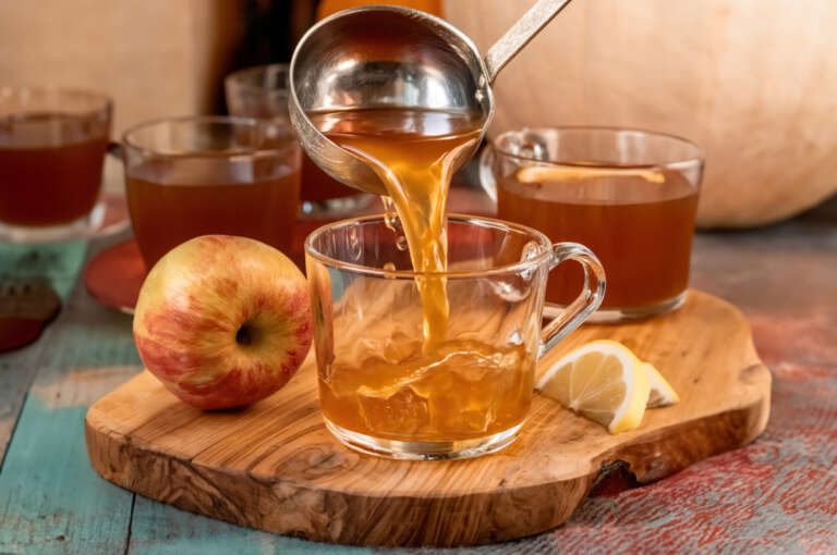Hot Honey Apple Tea being ladled into mugs