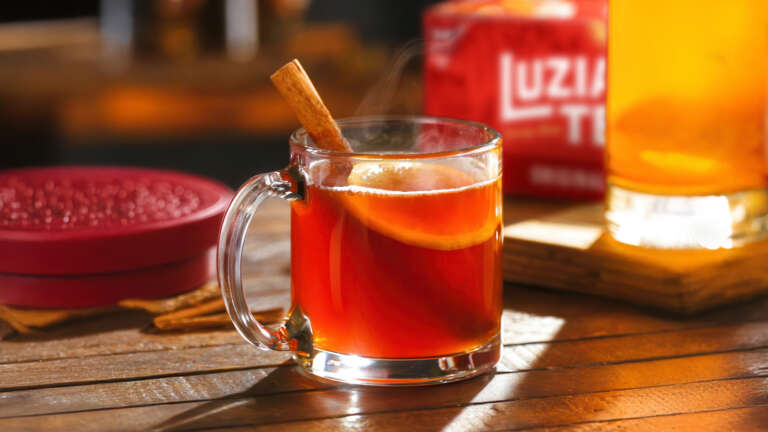 Maple Bourbon Tea Toddy in clear mug with cinnamon stick garnish