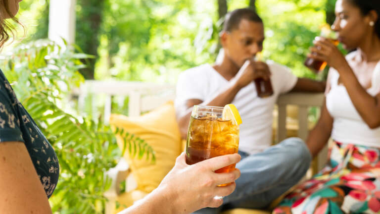 a couple on porch drinking iced tea